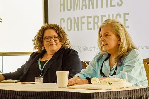 Honey Rand, PhD '00, (right) speaks at a USF Humanities Conference alongside the Humanities Institute's Liz Kicak.