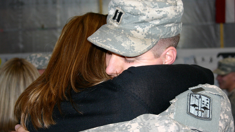 Samantha Tromly, program director of the USF Institute of Applied Engineering, embraces her husband, Maj. Kevin Tromly, following his return from deployment to Iraq