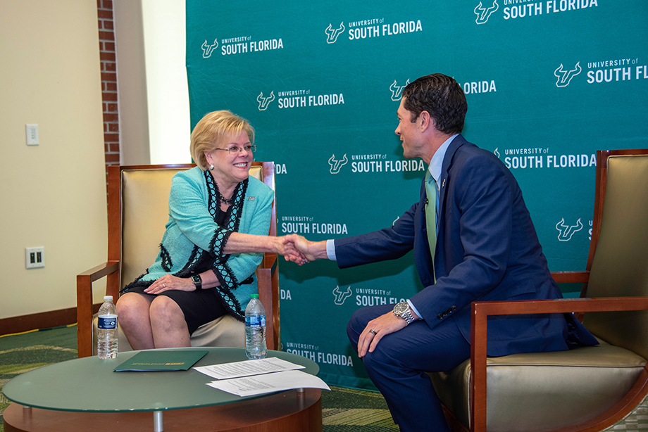 USF president Rhea Law at a Town Hall shaking the hand of the moderator, Adam Freeman, AVP for Communications and PR