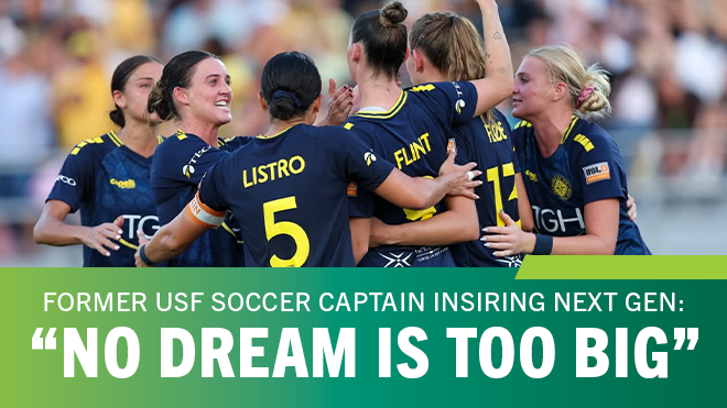 Soccer players smiling in a group hug