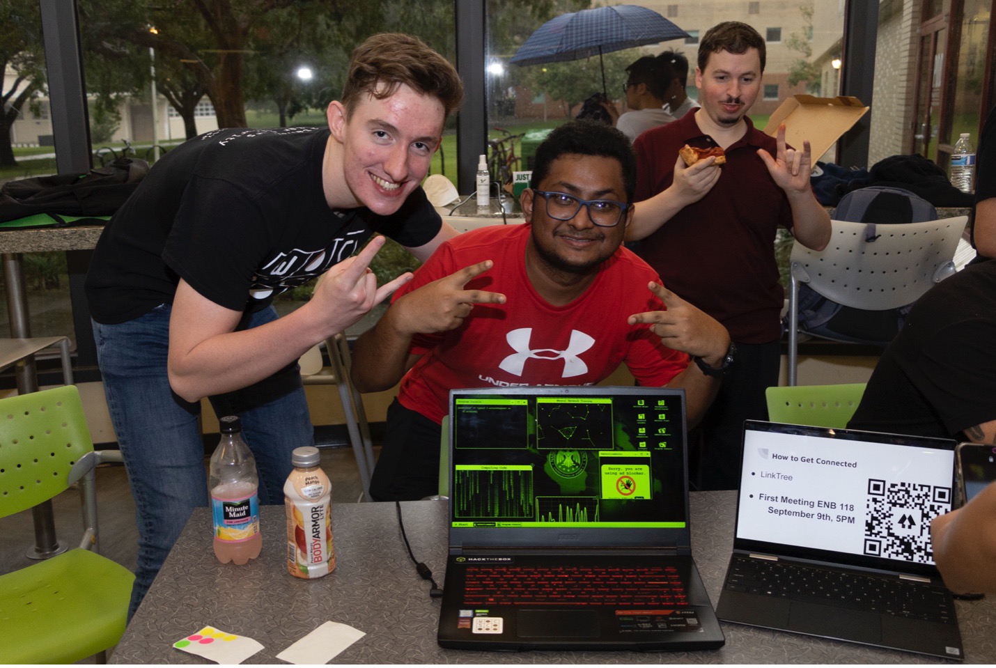 Three students smile at the camera