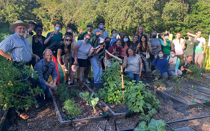 large group of people posing for picture in the USF Botanical Gardens