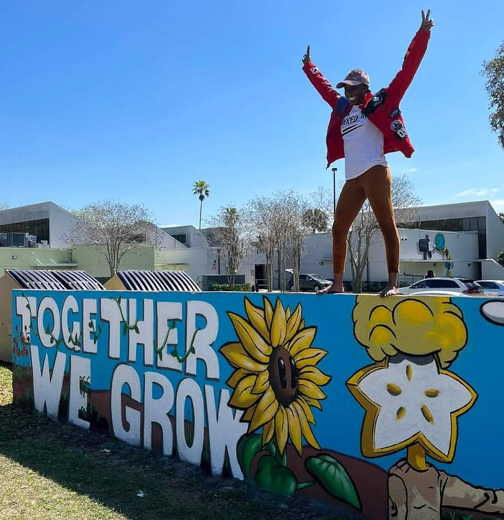 Winnie Mulamba on top of St Pete mural 