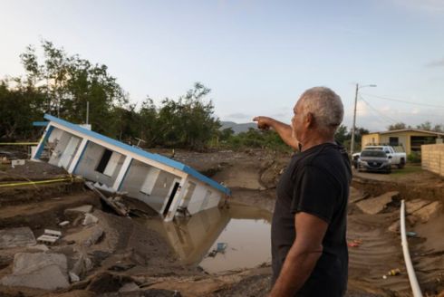 A man points to a home that was collapsed by Hurricane Fiona at Villa Esperanza in Salinas, Puerto Rico, Wednesday, September 21, 2022. Tampa Bay groups are sending help to the island after the hurricane. [ ALEJANDRO GRANADILLO | AP ]