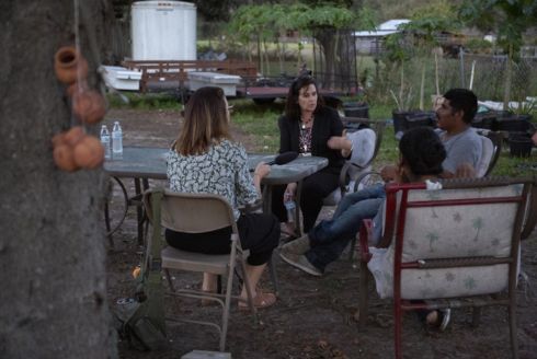 WUSF's Kerry Sheridan (from left), spoke to Carol Mayo, director of the Hillsborough County Migrant Education Program, and a family about the education of farmworkers and their children in early 2021.