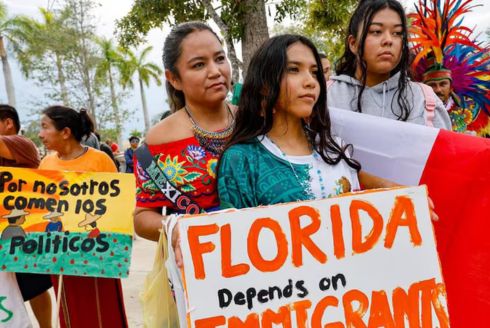 Gabriela Ibarra joins her daughters Kathy Camacho and Ashley Cruz as they listen to speakers at the 