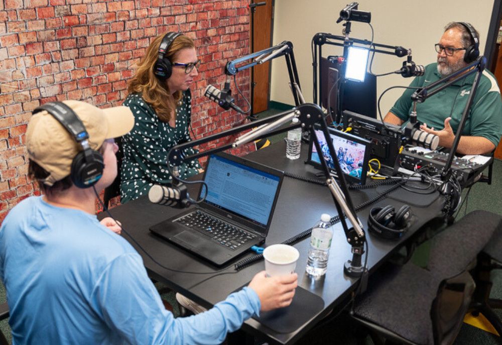 (From left) Dr. Josh Scacco, USF alumna Evelyn Perez-Verdia, and professor Wayne Garcia recording an episode of ‘By Conduct and Example.’ (Photo by Corey Lepak)