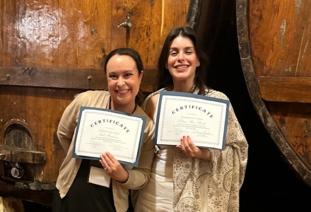 Musselman and Rios Barreto holding two certifcates.