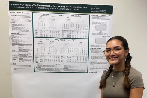 Kendall Smith standing in front of her research poster