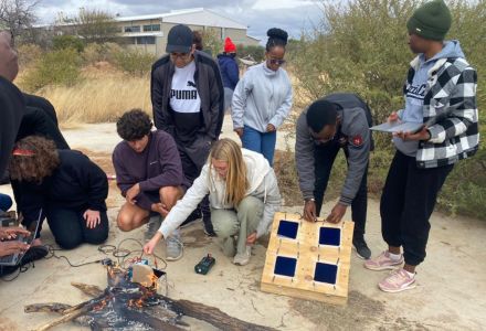 USF students demonstrating the solar cell enhancements with BIUST students. (Photo courtesy of Madison Orr)