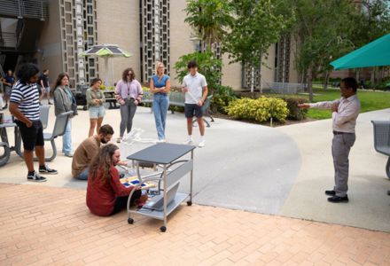 Dr. Witanachchi (right) instructing students testing solar cells outside ISA weeks before their trip to Botswana. (Photo by of Corey Lepak)