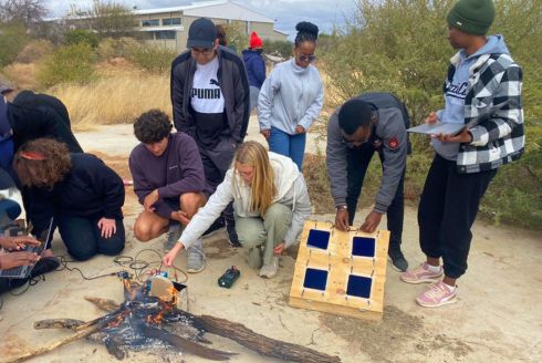 USF students demonstrating the solar cell enhancements with BIUST students. (Photo courtesy of Madison Orr)