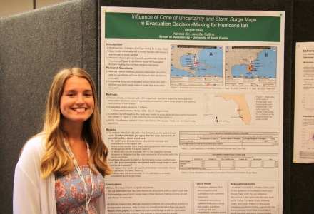 PhD student Megan Blair presenting her research, "Influence of the Cone of Uncertainty and Storm Surge Maps in Evacuation Decision Making for Hurricane Ian," at the poster symposium. (Photo courtesy of Yijie Zhu)