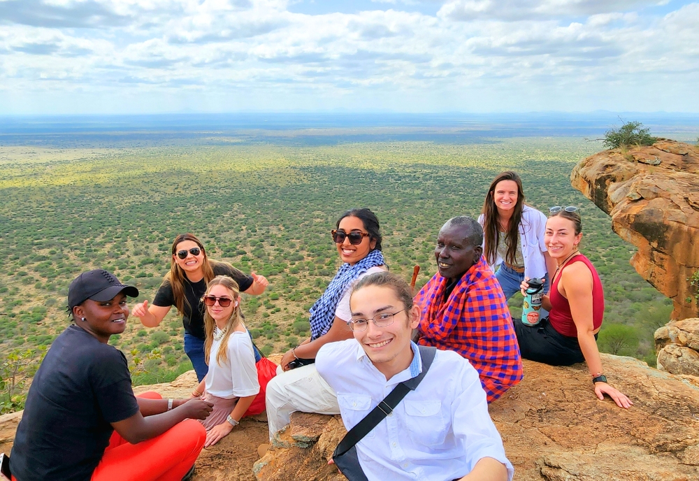 Students enjoying ‘lunch with a view’ from an outlook in Mbrikiani Ranch, Kajiado County, Kenya. They made the trek with a Maasai man who brought them there when we they asked him for a nice spot to have lunch. (Photo courtesy of Dr. Dillon Mahoney)