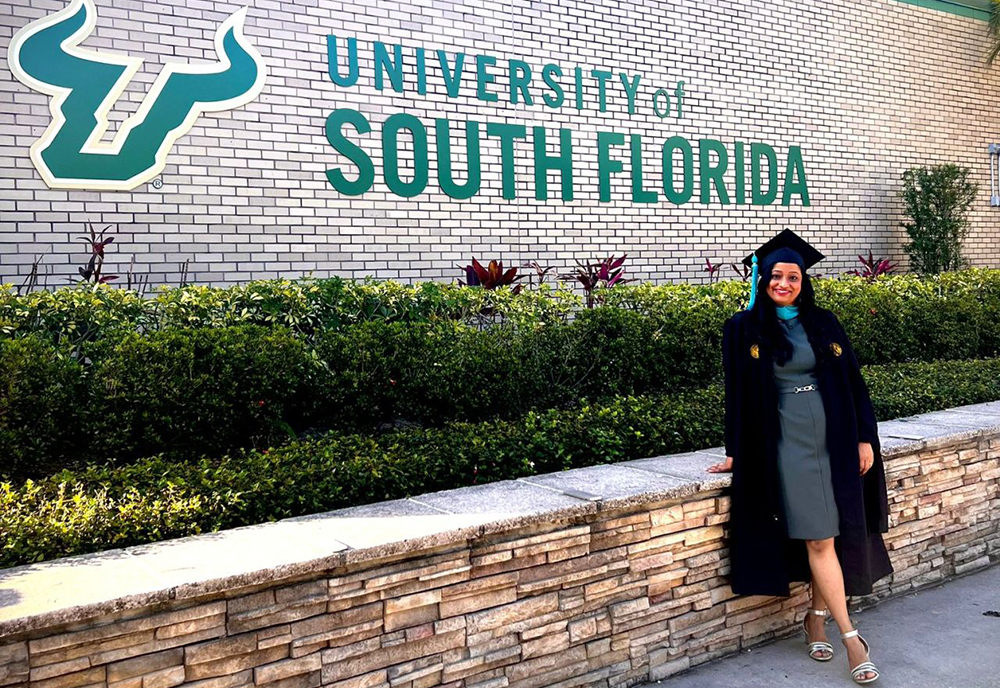 Aditi Sugeerappa Hoti poses by the University of South Florida sign after her graduation ceremony. (Photo courtesy of Aditi Sugeerappa Hoti)