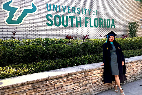 Aditi Sugeerappa Hoti poses by the University of South Florida sign after her graduation ceremony. (Photo courtesy of Aditi Sugeerappa Hoti)