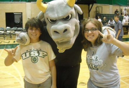 During her sophomore year, Rachel Gilmore (right) posed with USF’s mascot, Rocky the Bull, at a sporting event. (Photo courtesy of Rachel Gilmore)