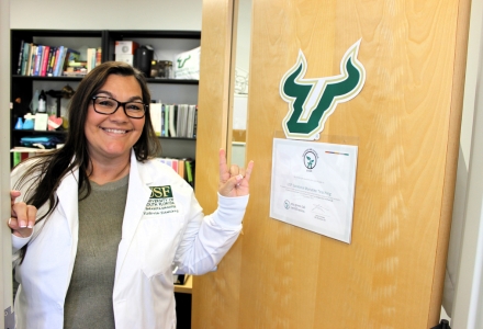 Teaching Lab Manager Victoria Ramirez proudly displays the new Green Lab Certification. (Photo courtesy of Victoria Ramirez)