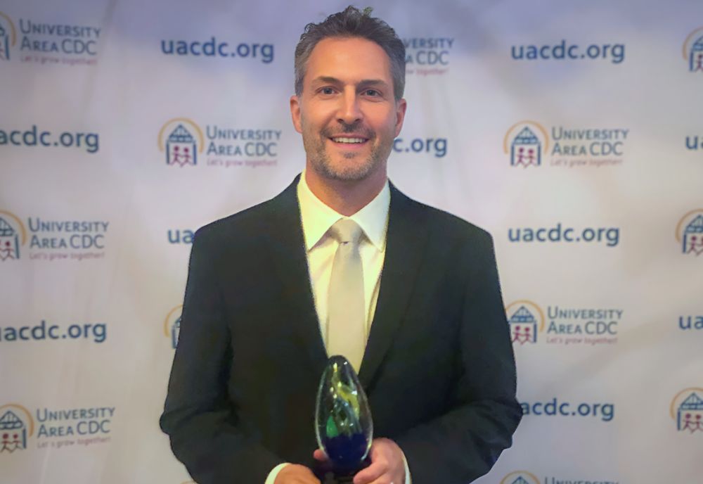 Dr. Christian Wells at the University Area CDC’s Award Ceremony with his newly received Advocate Award. Photo courtesy of Christian Wells.