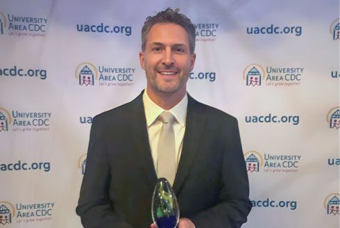 Dr. Christian Wells at the University Area CDC’s Award Ceremony with his newly received Advocate Award. Photo courtesy of Christian Wells.