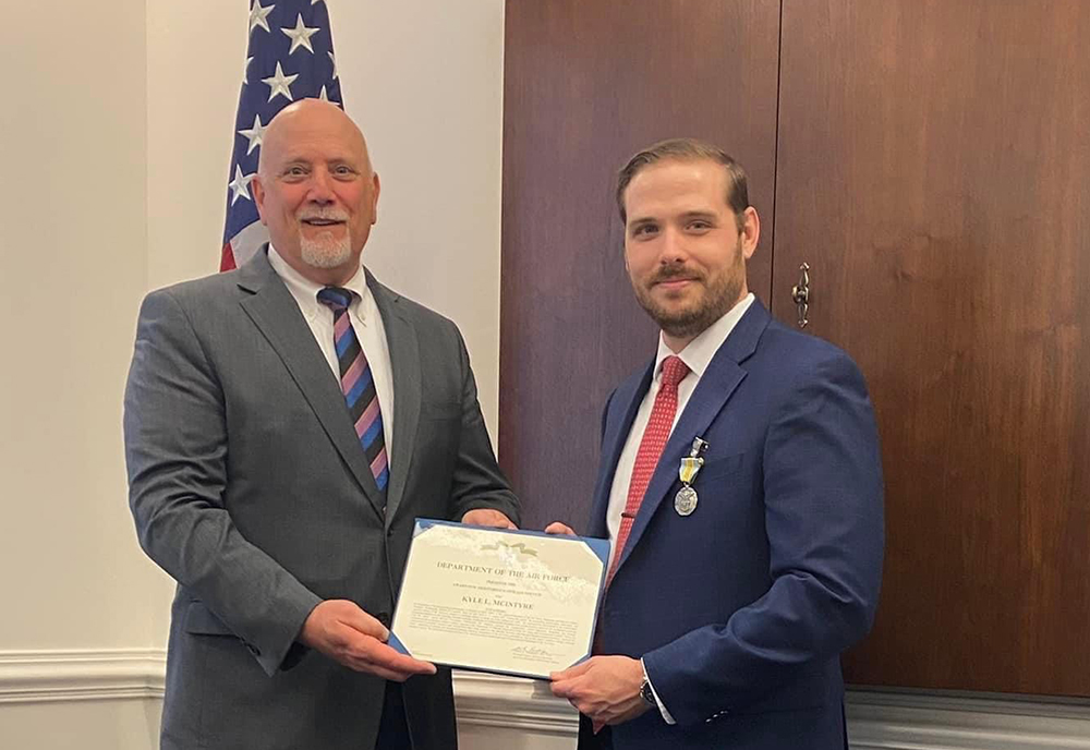 Kyle McIntyre (right) receiving the Meritorious Civilian Service Medal from then acting Assistant Secretary of the Air Force, Mr. John Fedrigo (left), while serving as Fedrigo’s Chief of Staff (2022). (Photo courtesy of Kyle McIntyre)