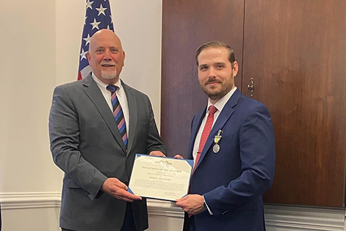 Kyle McIntyre (right) receiving the Meritorious Civilian Service Medal from then acting Assistant Secretary of the Air Force, Mr. John Fedrigo (left), while serving as Fedrigo’s Chief of Staff (2022). (Photo courtesy of Kyle McIntyre)