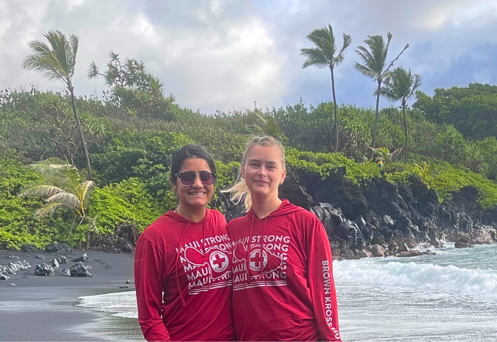 Dougherty (left) and Kaila Witkowski, an assistant professor at Florida Atlantic University, at the black sand beach with Maui Strong sweatshirts that they purchased from Brown Kross Hui (BKH), a grassroots organization. The funds from these shirts go directly to support BKH's efforts to get displaced families’ furnishings in the homes they have been able to obtain. (Photo courtesy of Ratna B. Dougherty)