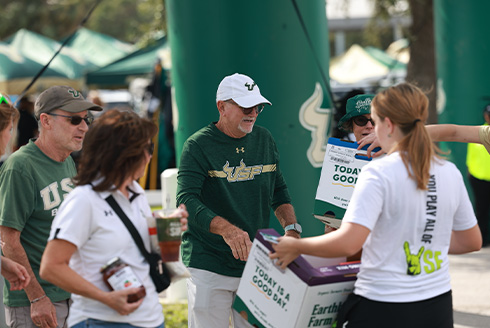 USF volunteers carrying boxes of food