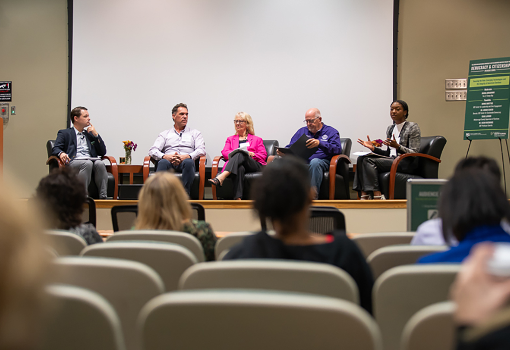 (From Left) Center for Sustainable Democracy Director Dr. Joshua Scacco with panelists Dennis Mont’Ros (Student Programs Coordinator, Center for Leadership and Civic Engagement), Dr. Susan MacManus (USF Professor Emerita), Craig Latimer (Hillsborough County Supervisor of Elections), and moderator Briona Arradondo from Fox 13. (Photo by Corey Lepak)