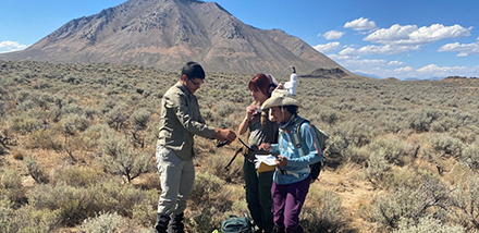 Gavin Martinez, Bianca Hayes, and Gabriella Jean-Baptiste preparing to collect a magnetic survey over a lava flowwith a fissure in Idaho. (Photo courtesy of Dr. Sarah Kruse)