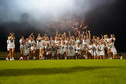 The USF women’s lacrosse team celebrates a victory in their inaugural game. [Photo courtesy of USF Athletics]