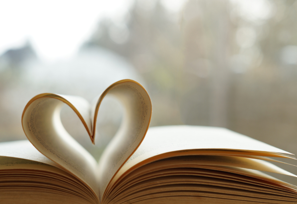 open book with pages folded to make a heart shape