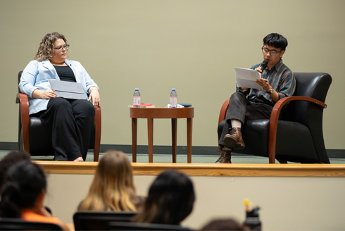 Humanities Institute director Elizabeth Kicak (left) with poet Ocean Vuong (right) during the Institute's latest poetry reading in November. Photo by Corey Lepak.