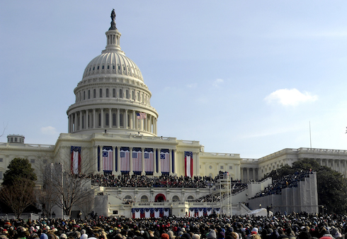 US capitol building with flags and crowd