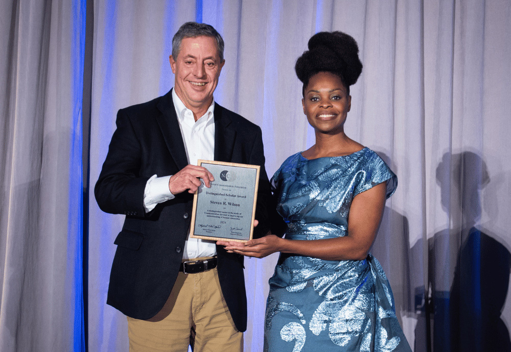 Steven Wilson (left) was formally recognized at an awards ceremony at the National Communication Association (NCA) annual meeting in New Orleans this past November (2024). Wilson is pictured with Dr. Marnel Niles Goins, NCA President and Dean of the School of Communication at American University. The Distinguished Scholar Award is the highest award given by NCA. Wilson delivered a short talk about his career at the meeting and thanked those who have mentored and supported him over the years. “I look forward to continuing to pass that on to the graduate students I work with now,” he said. (Photo courtesy of Dr. Kai Kuang)