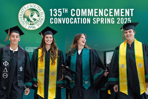 graduates in caps and gowns standing below USF seal