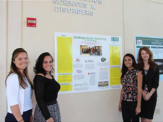 students standing beside bulletin board