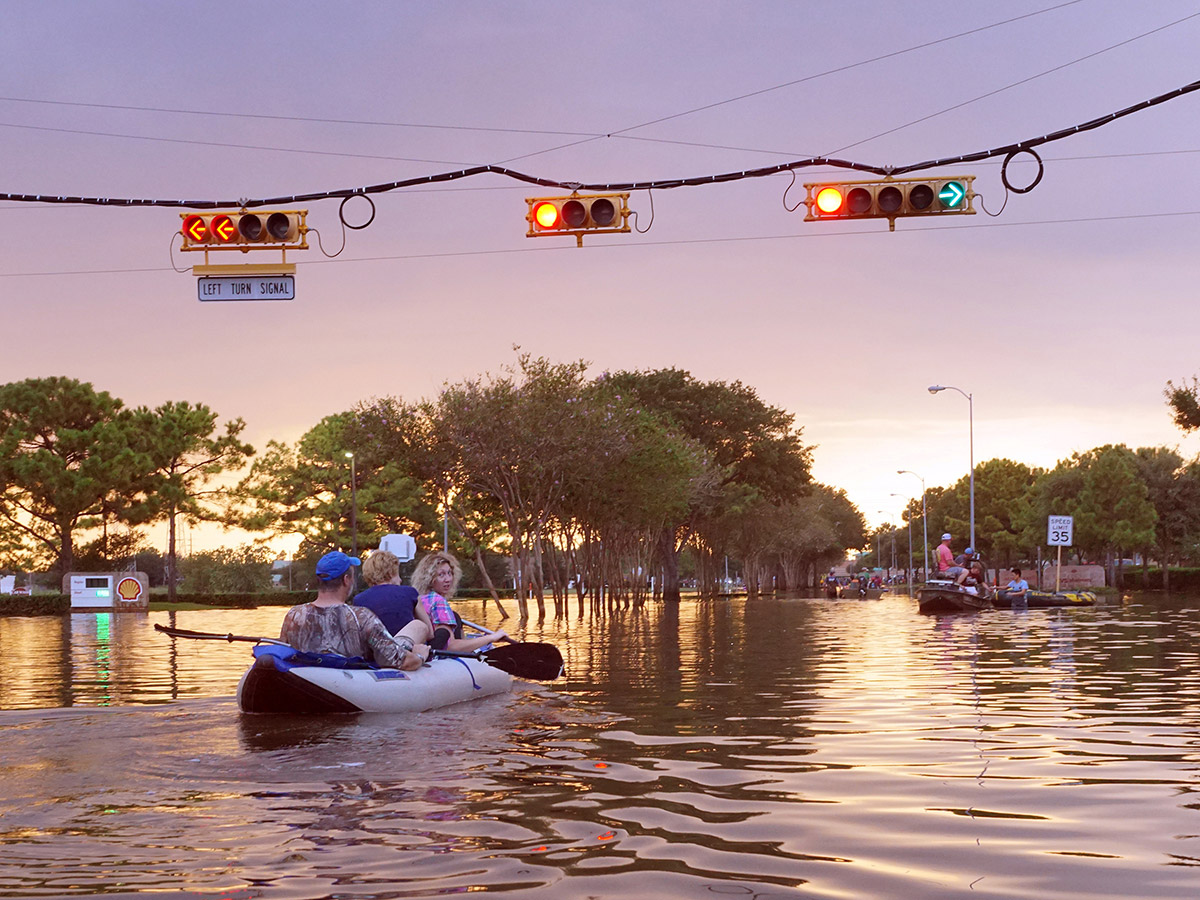 team in a canoe through town