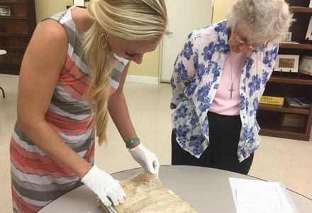 La Florida Associate Director Rachel Sanderson with archivist Sister Catherine Bitzer examining the collection’s 16th-century records.
