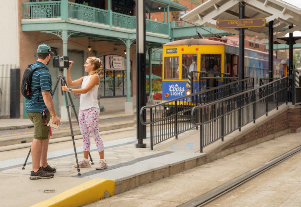 Students Sean Wissler (left) and Amber Brocki (right) laser-scan the HART TECO streetcars at Centro Ybor Station. (Photo by Alessandra Casanova)
