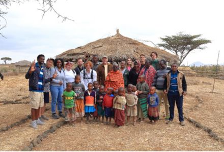 USF students and Dr. Sarath Witanachchi pose for photo with residents in rural African community. (Photo courtesy of Sarath Witanachchi)
