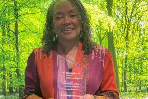 Dr. Cheryl Rodriguez holds Dr. Ira E. Harrison Legacy Award