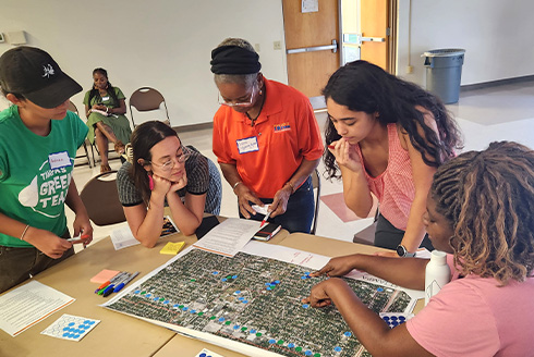 Community members in East Tampa identifying neighborhood amenities and walking distances during the East Tampa community engagement workshop for the heat vulnerability study