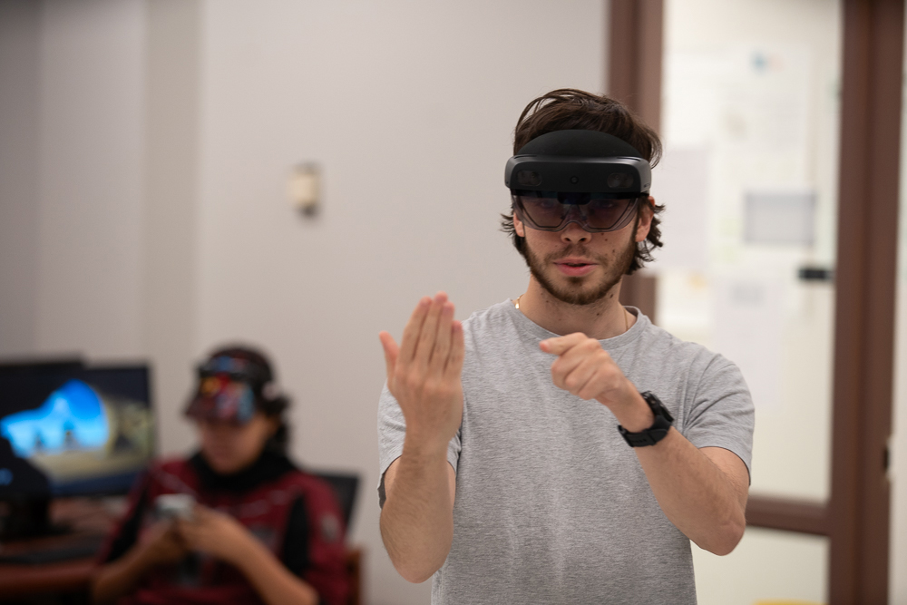 A student in Dr. Carney’s Digital Dinosaur course using a VR headset.