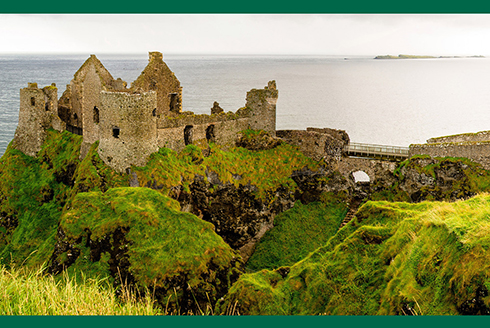 castle ruins on cliffside in Ireland