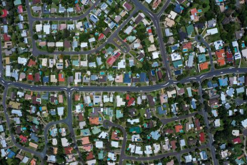 aerial view of neighborhood houses with roads spiraling through