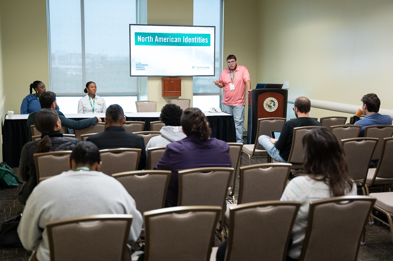 Students presenting in a panel room