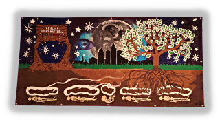 Photo of visual artwork by Lakeema Matthew painted on a large rectangular canvas positioned horizontally. The work depicts a nighttime landscape with the moon, stars, and cityscape in the background. The foreground is a cutaway of the Earth’s surface revealing various symbols above and below the ground. On the left, two large, bare tree trunks emerge from the ground, their branches transforming into the shape of two hands holding a sign that reads “Do Black Lives Matter…Even In Death?”. On the right, there is a large tree whose roots extend into the soil where they are connected to five souls (depicted as human silhouettes of various ages ), leaving their bodies (depicted as skeletons of various corresponding ages) directly underneath them.