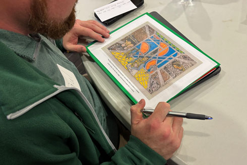 A student looks at a print of an artwork.