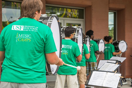 Students performing as part of the drumline.